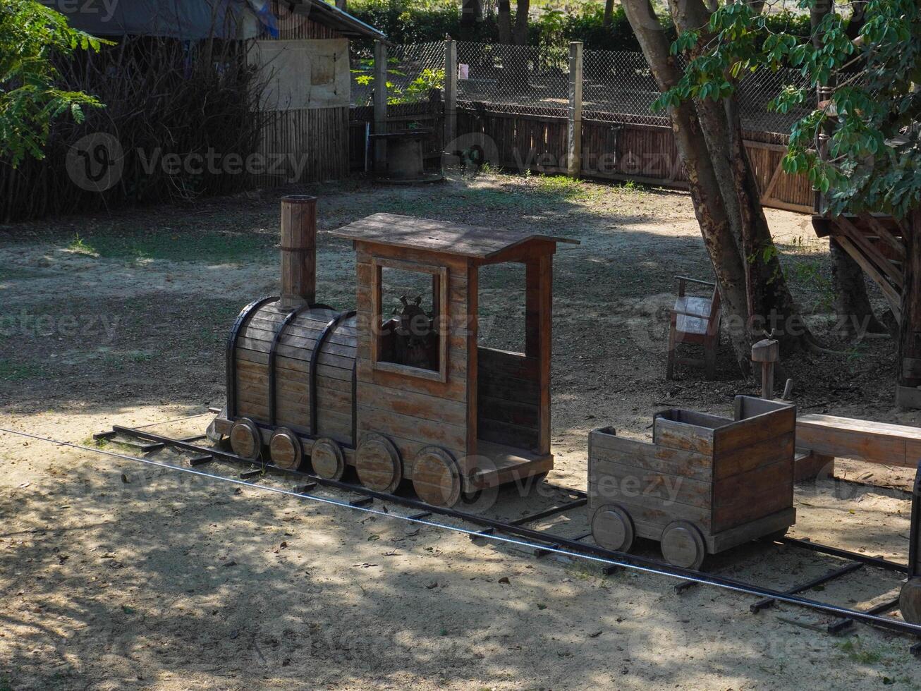 Summer park playground with swings, slides and climbing equipment. Modern wooden playground equipment for children's amusement park. photo