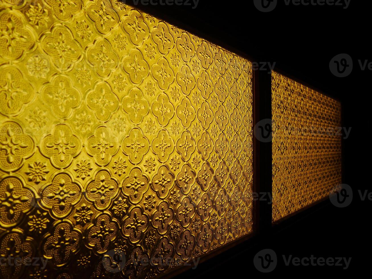 A window with a gold pattern photo