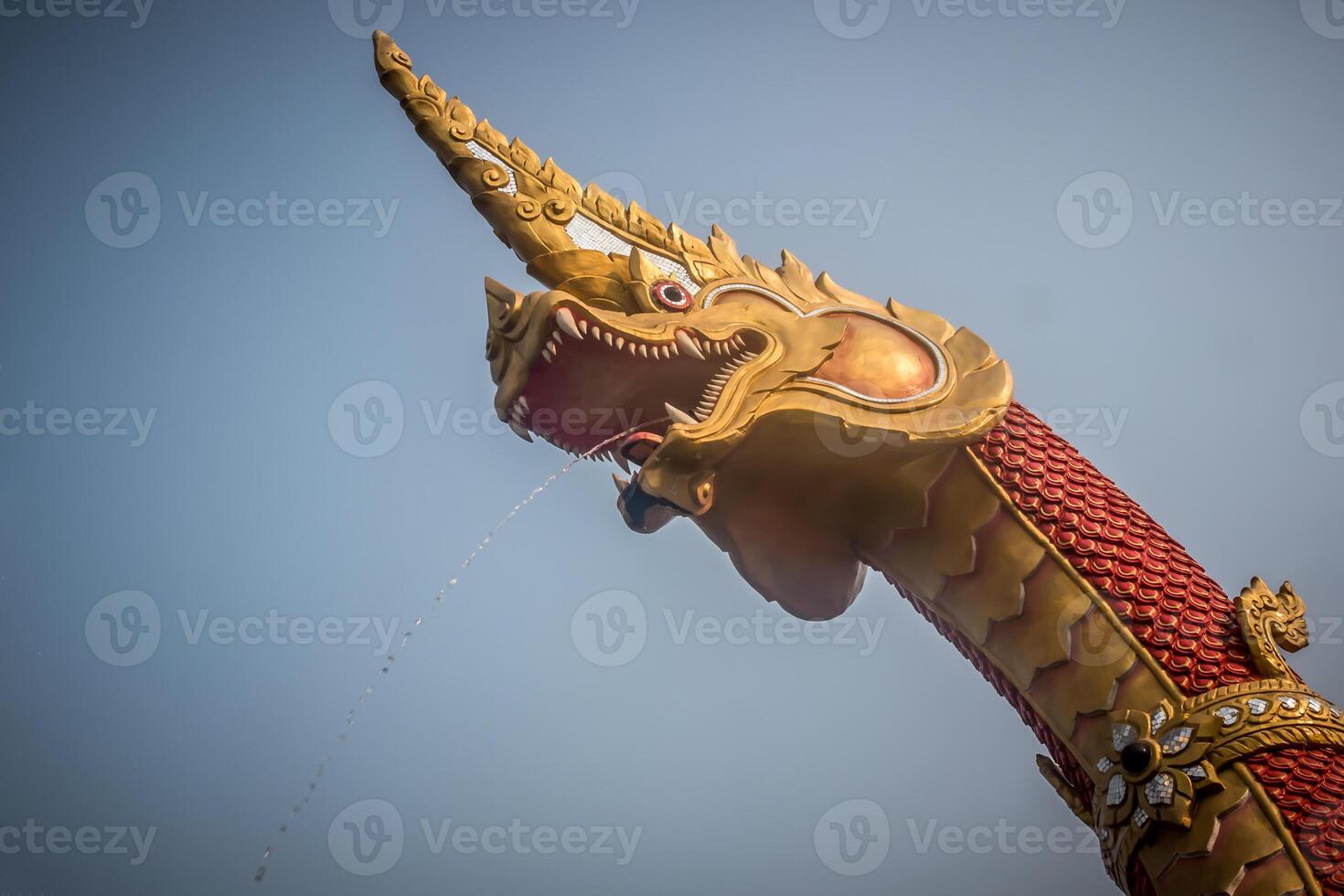 A dragon statue with a long tail photo
