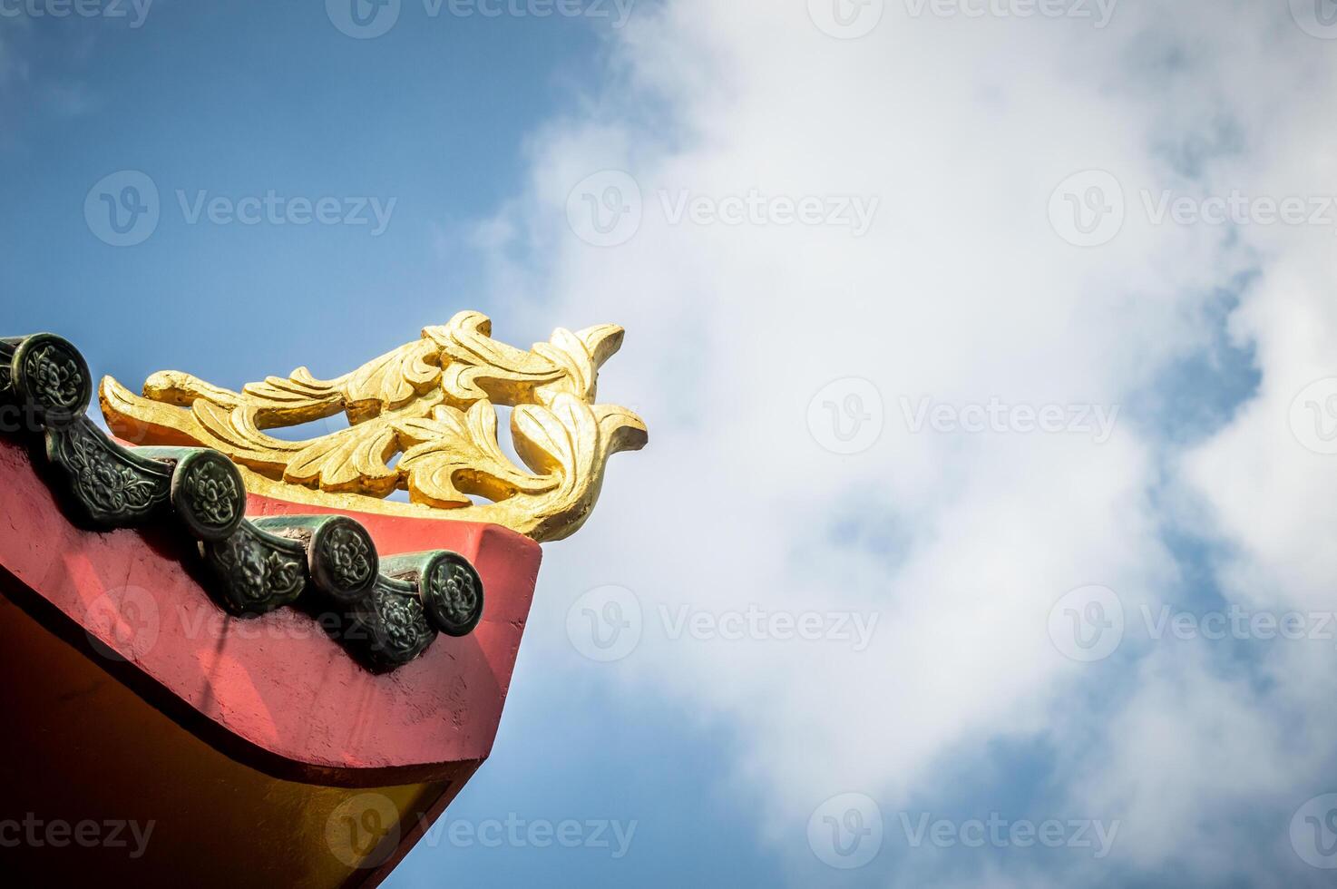A chinese roof with a gold and red design photo
