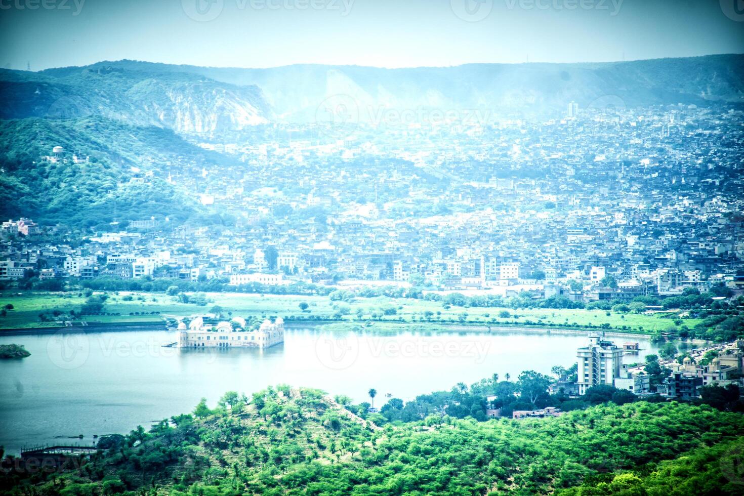 A view of a city and lake from a hill photo