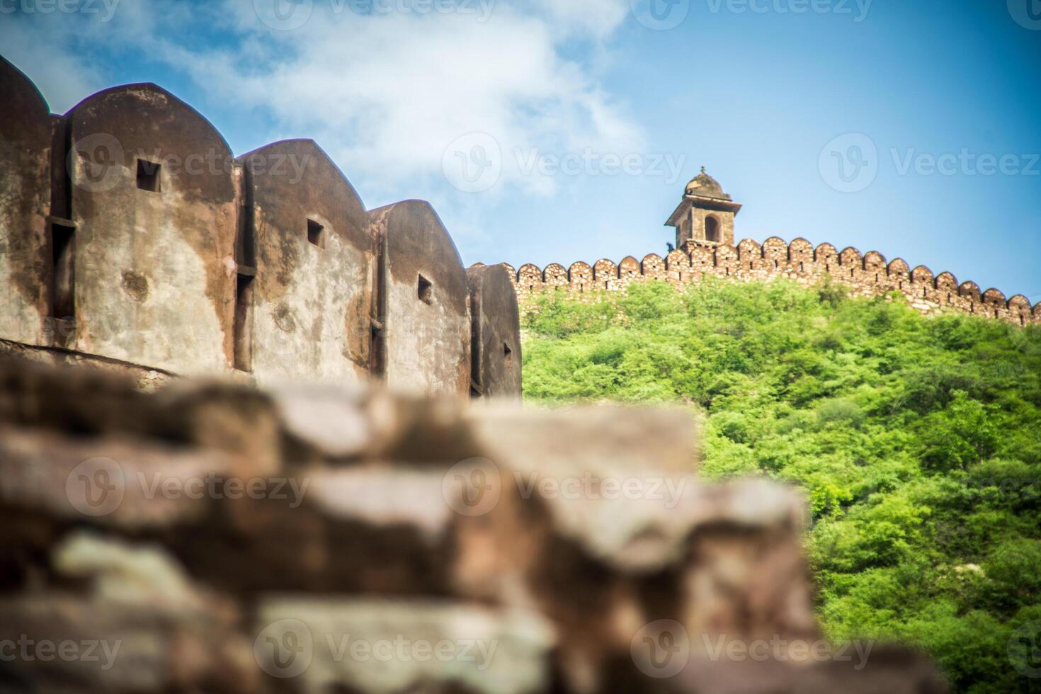 A stone wall with a tower on top of it photo