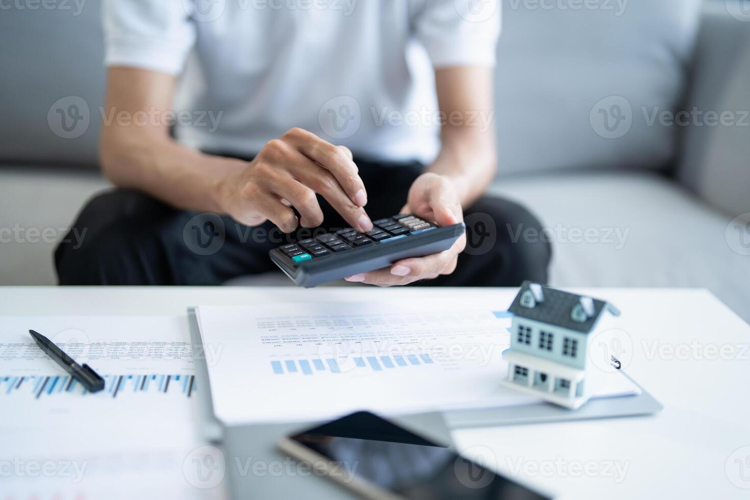 Man calculate finances home pay bills taxes savings economy financial at home photo
