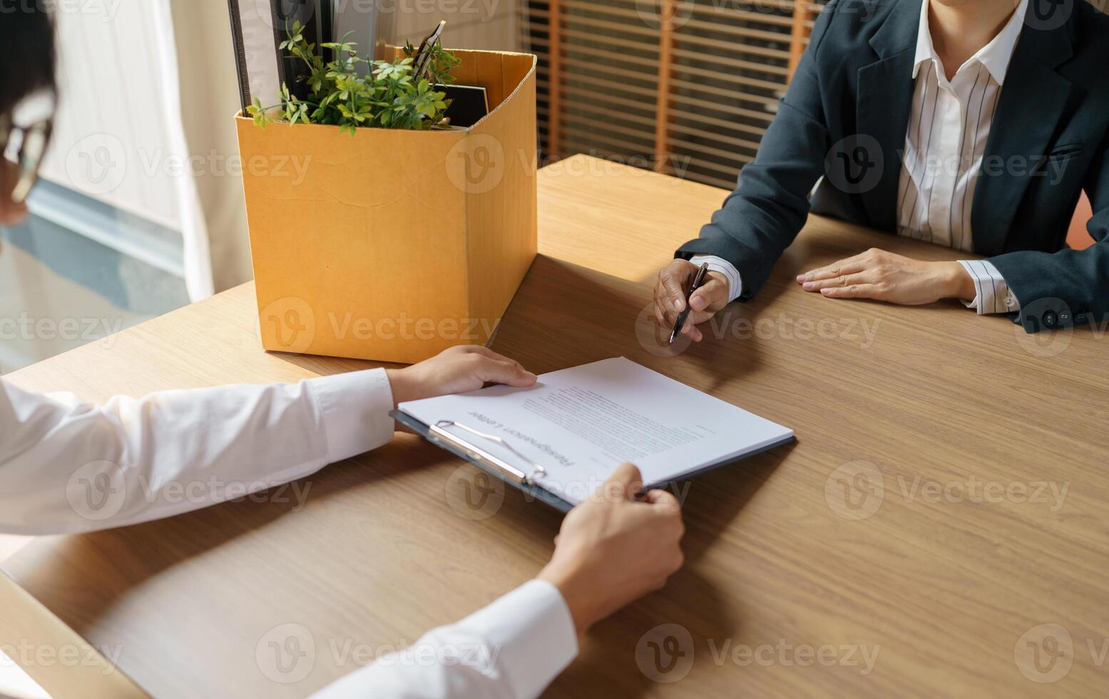 Quit Job Business man sending resignation letter and packing Stuff Resign Depress or carrying business cardboard box in office. Change of job or fired from company. photo