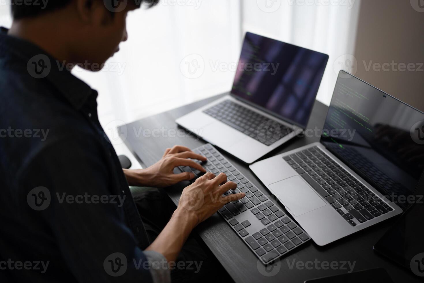 Asian man software engineer Working on Computer at office desk for writing program code IT Software Engineer finding errors tech support devops creating digital photo