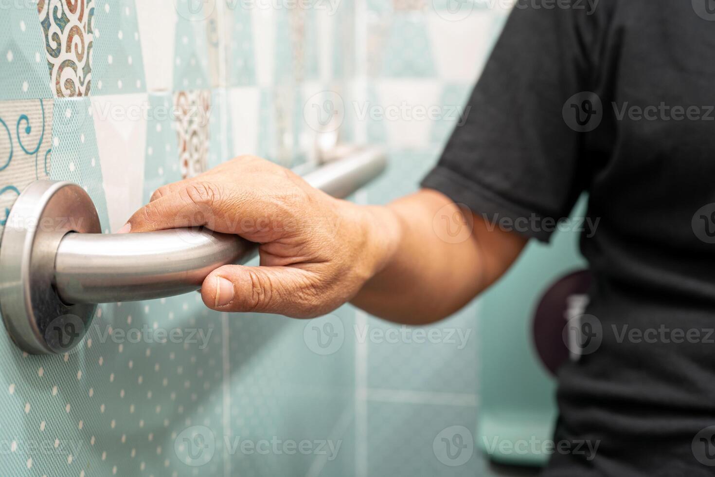 Asian elderly woman use toilet bathroom handle security, healthy strong medical. photo