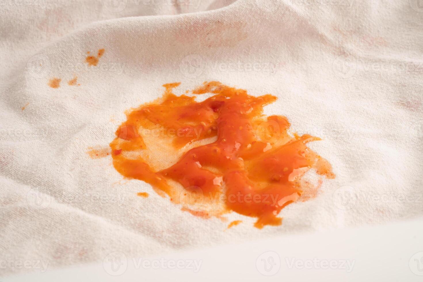 Dirty tomato sauce stain or ketchup on cloth to wash with washing powder, cleaning housework. photo