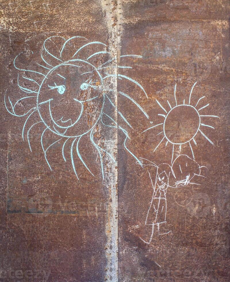 Children's drawing with chalk on a metal tin photo