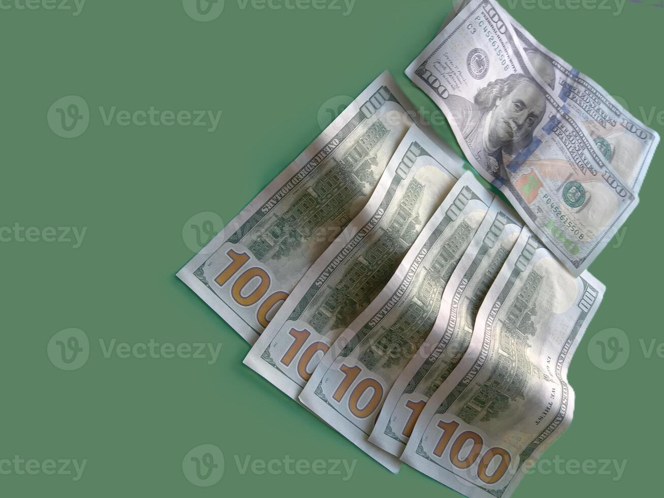 A stack of green 100 bills. Concept of wealth and prosperity. The green color of the bills and the green background create a harmonious and calming atmosphere. photo
