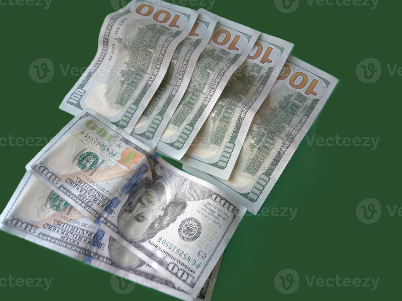 A stack of green 100 bills. Concept of wealth and prosperity. The green color of the bills and the green background create a harmonious and calming atmosphere. photo
