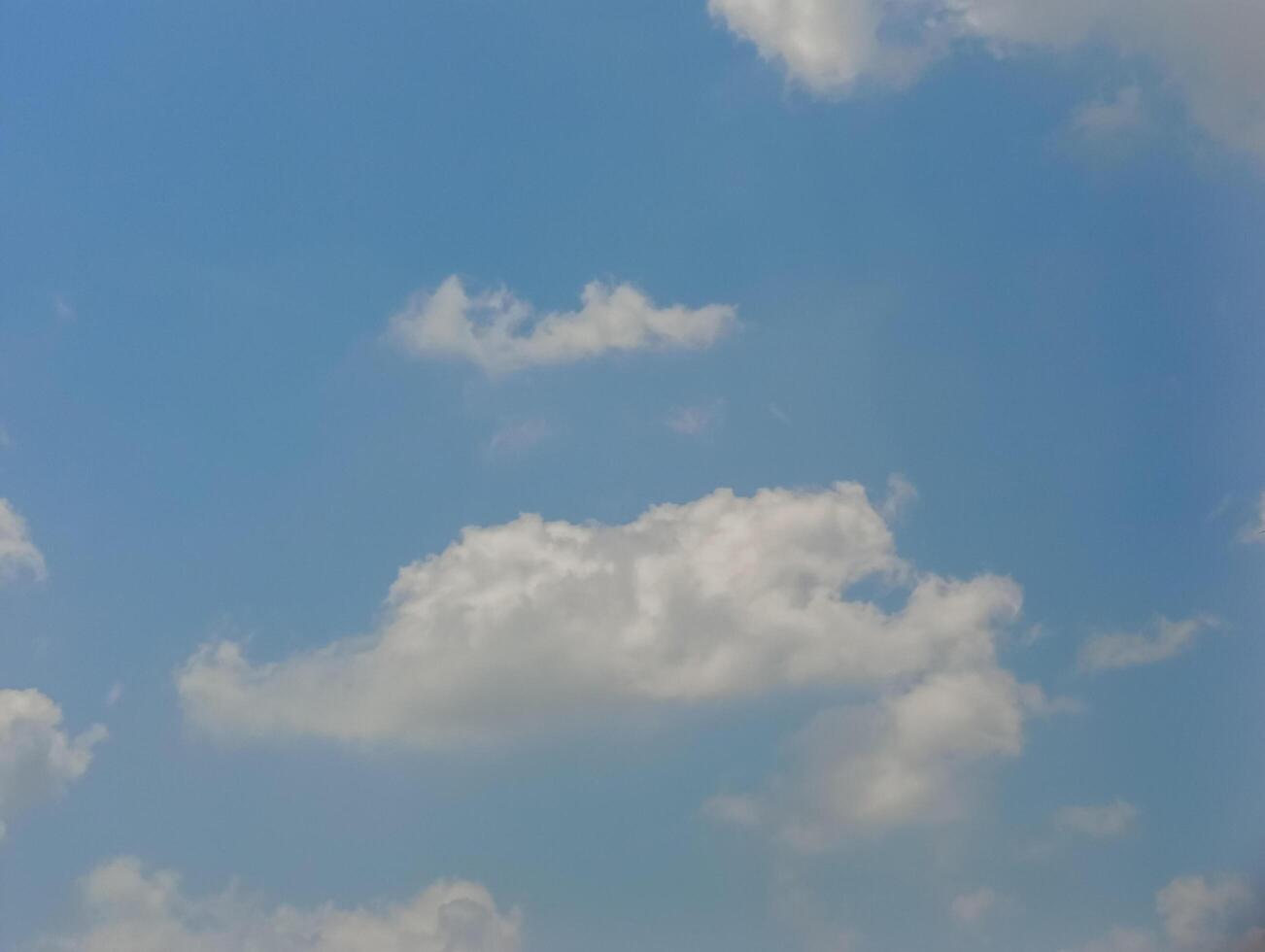 The sky was bright blue with pure white clouds like soft cotton. Full frame shot. Cloudly sky blue sky background photo