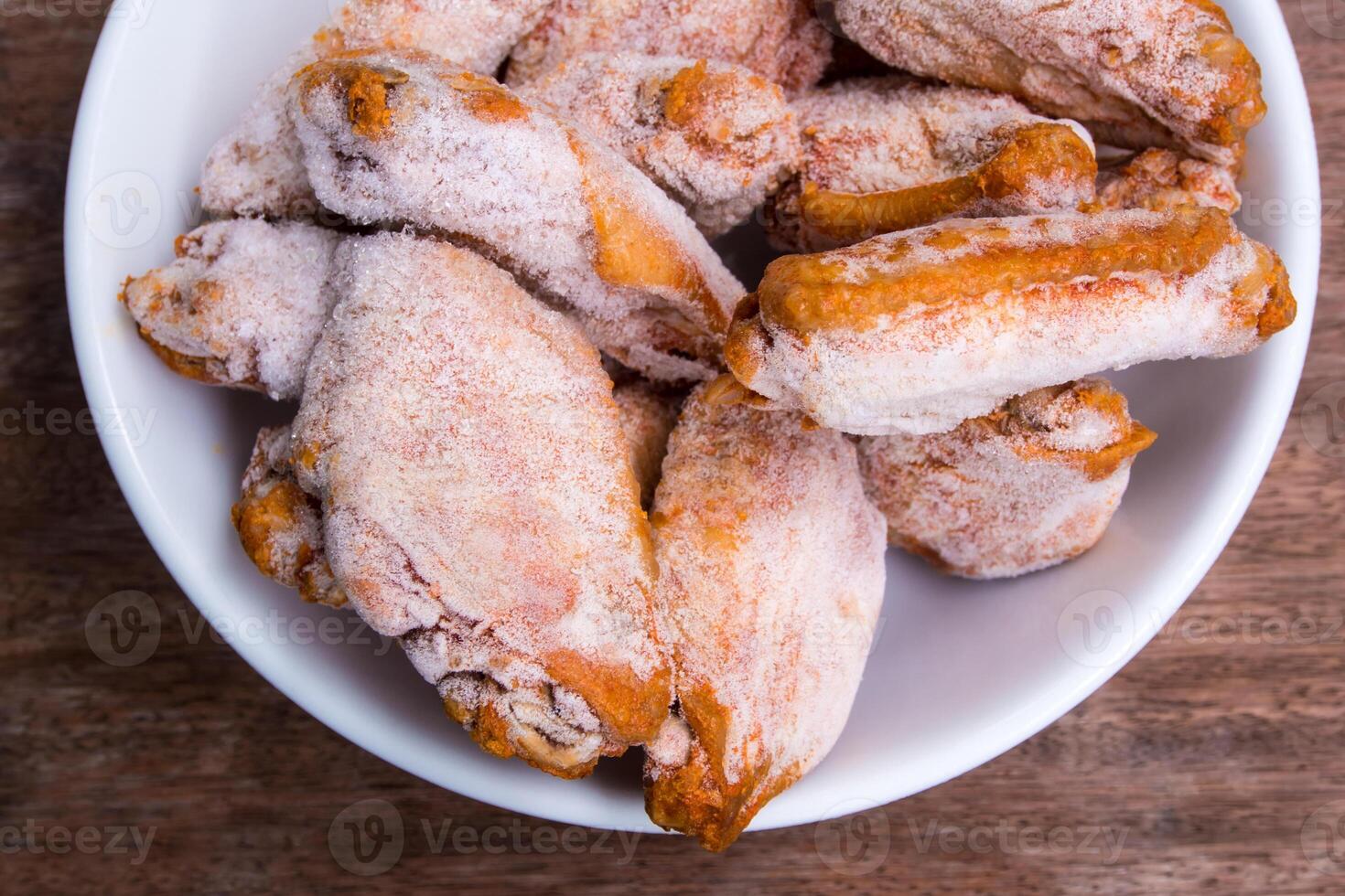 Some pieces of frozen fried chicken wings photo