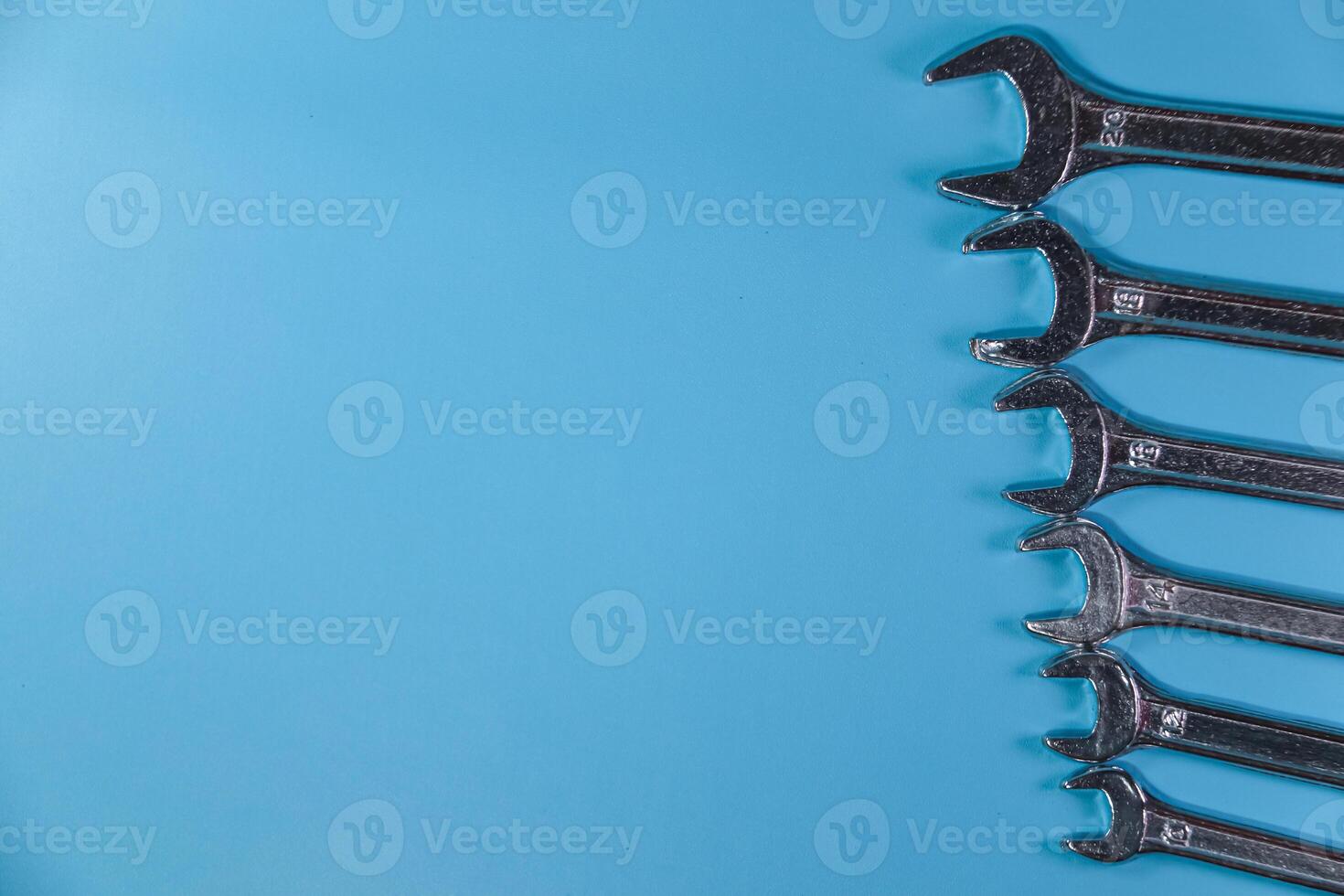 stainless wrench set on blue background photo