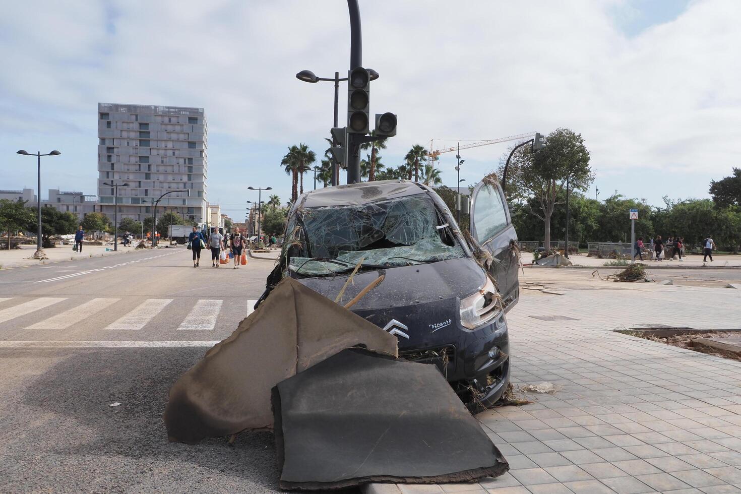 VALENCIA, SPAIN OCTOBER 31, 2024. Wrecked car and debris illustrating the devastating aftermath of flooding in Valencia, Spain photo
