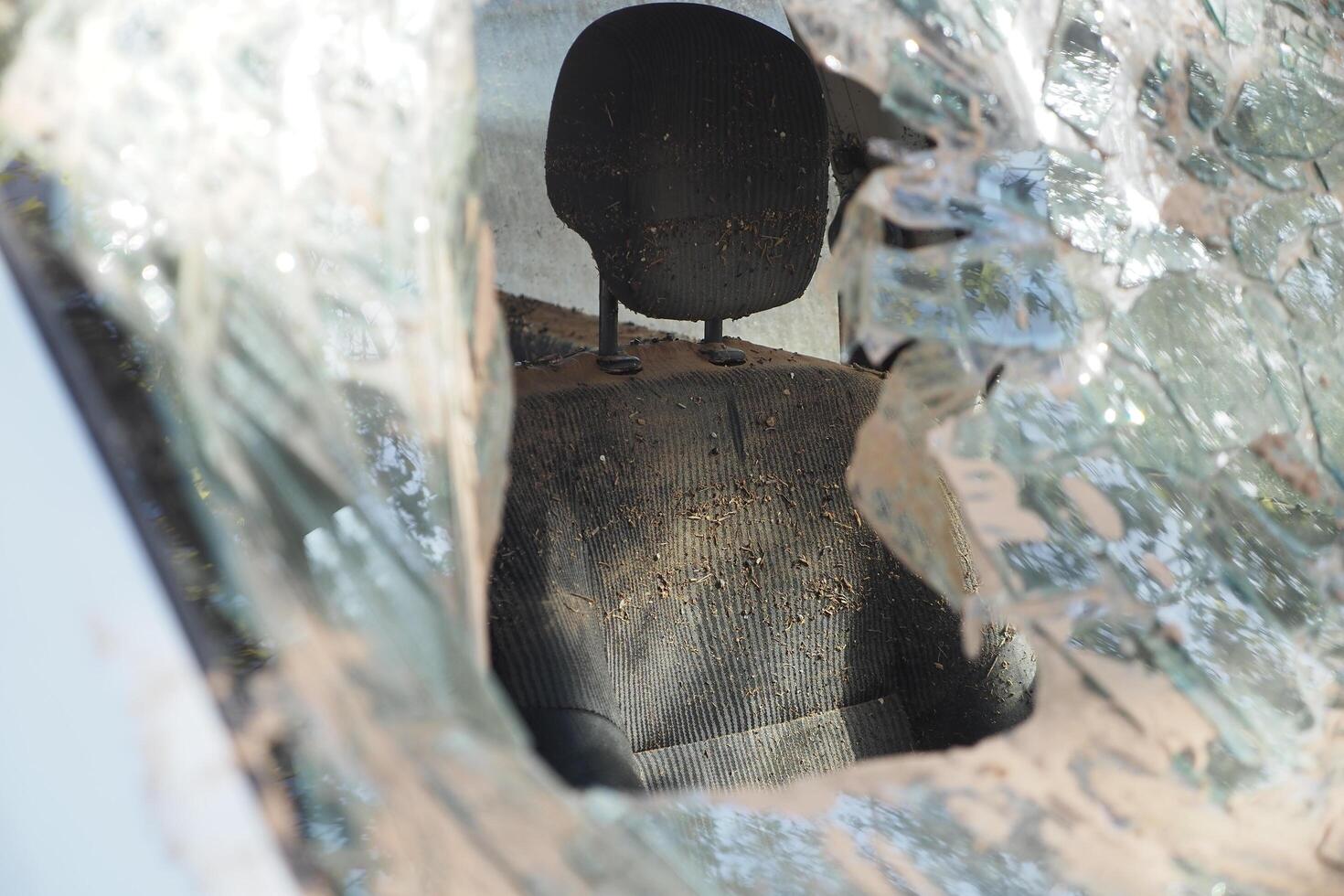 VALENCIA, SPAIN OCTOBER 31, 2024. Mud caked car interior viewed through a shattered windshield, highlighting the aftermath of severe flooding in Valencia photo