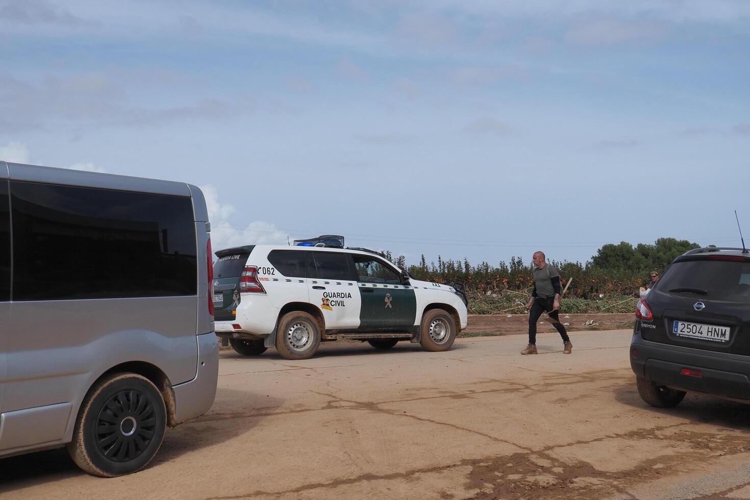 VALENCIA, SPAIN OCTOBER 31, 2024. Devastating consequences of flooding in Valencia as guardia civil patrols affected orange fields photo