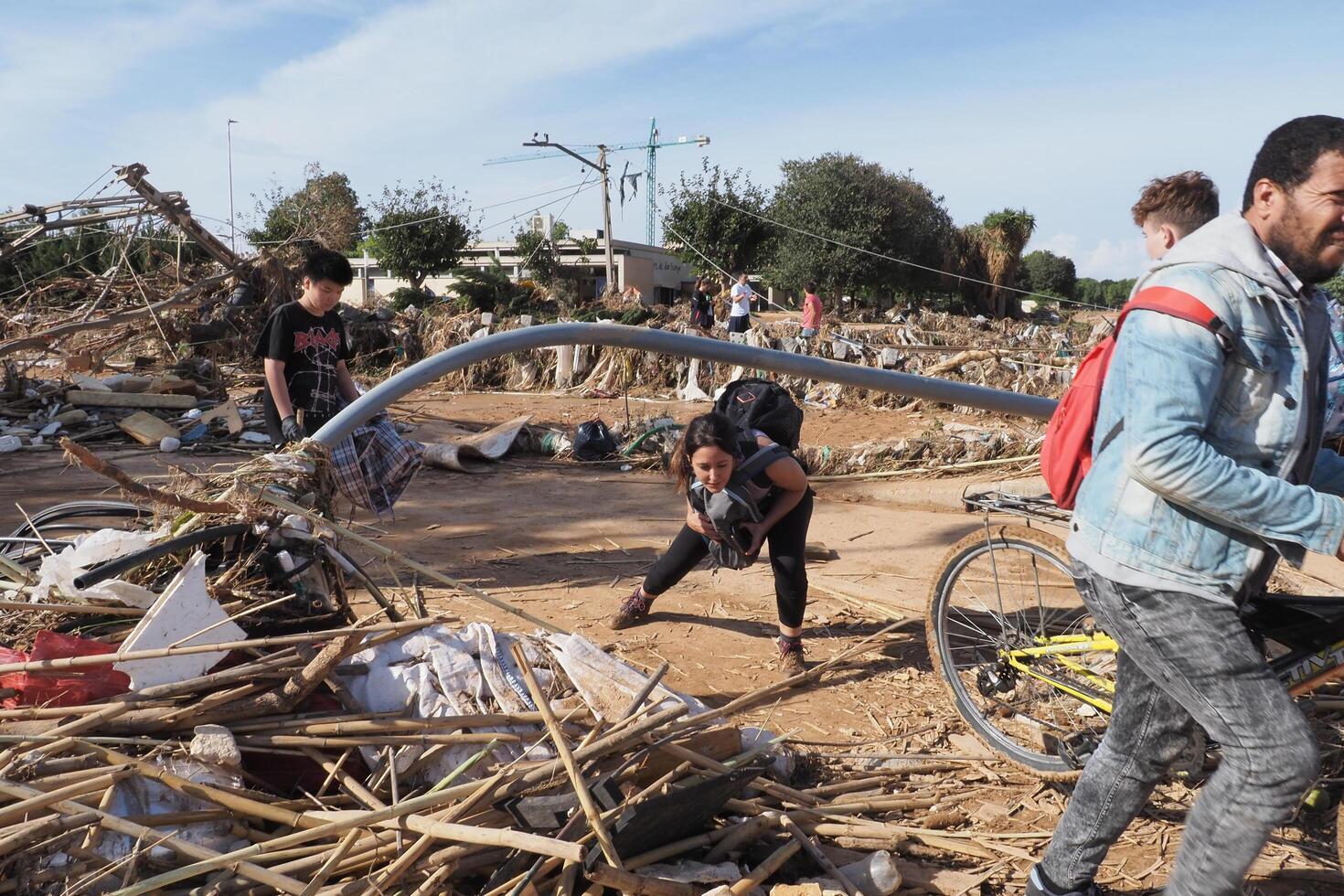 VALENCIA, SPAIN OCTOBER 31, 2024. Residents salvaging belongings amidst debris after a devastating flood in Valencia photo