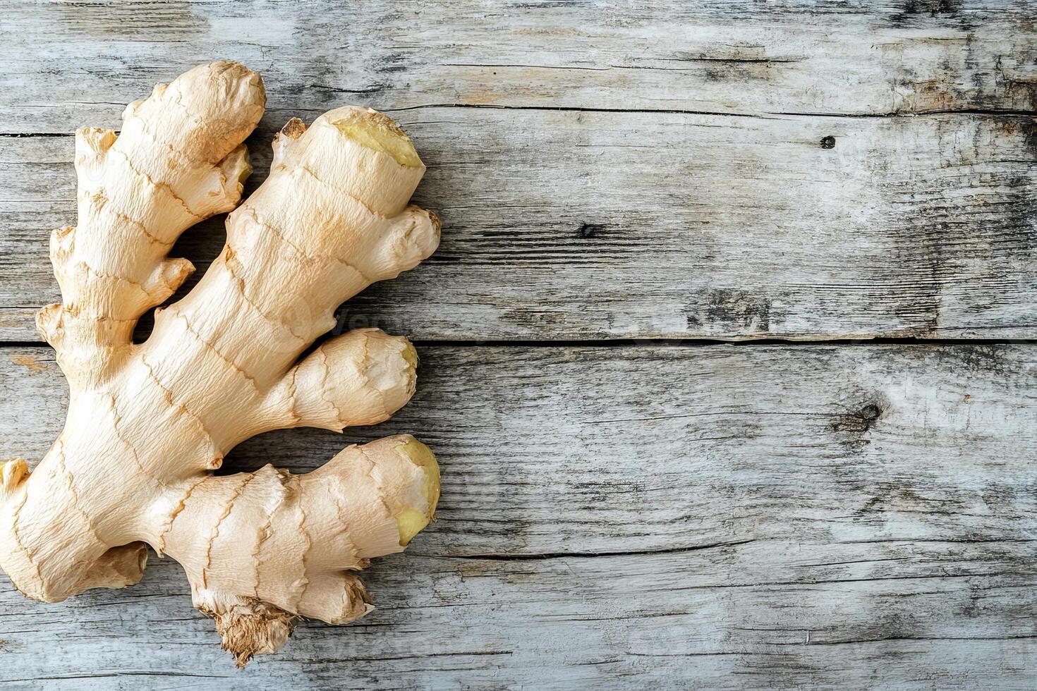 A high-resolution image of a fresh ginger root on a rustic wooden background, perfect for product placement and text overlay photo