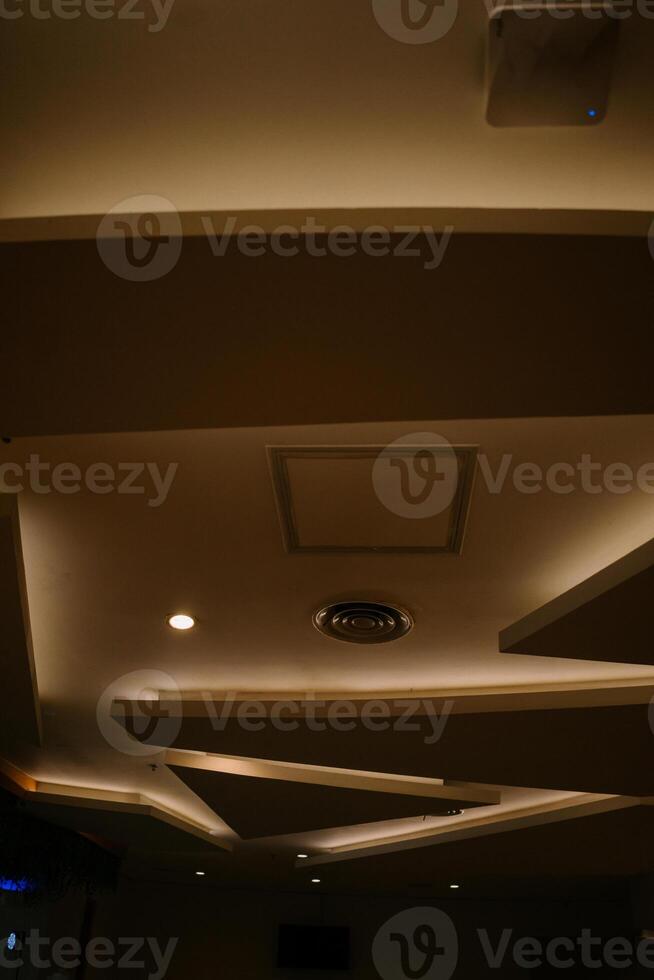 Elegant and luxurious hotel ceiling with intricate design and soft lighting, photo