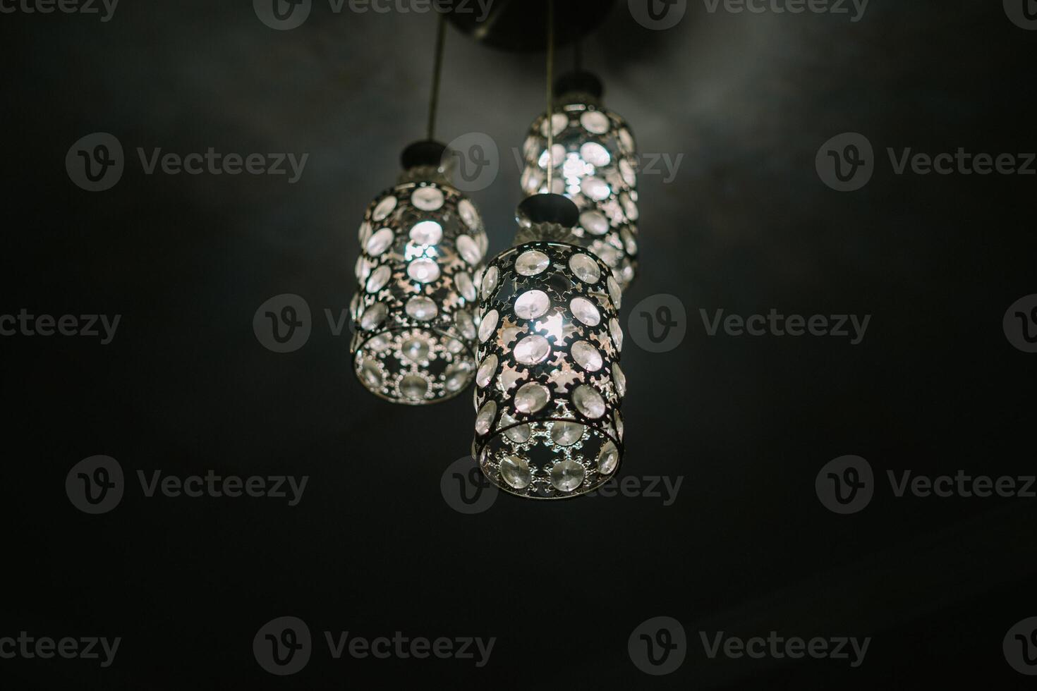 An elegant chandelier hanging in a luxury home, emitting warm light and showcasing intricate design photo