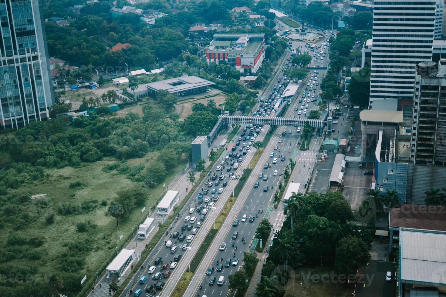 High-rise buildings and a major road in Jakarta city, with visible air pollution creating a hazy urban atmosphere photo