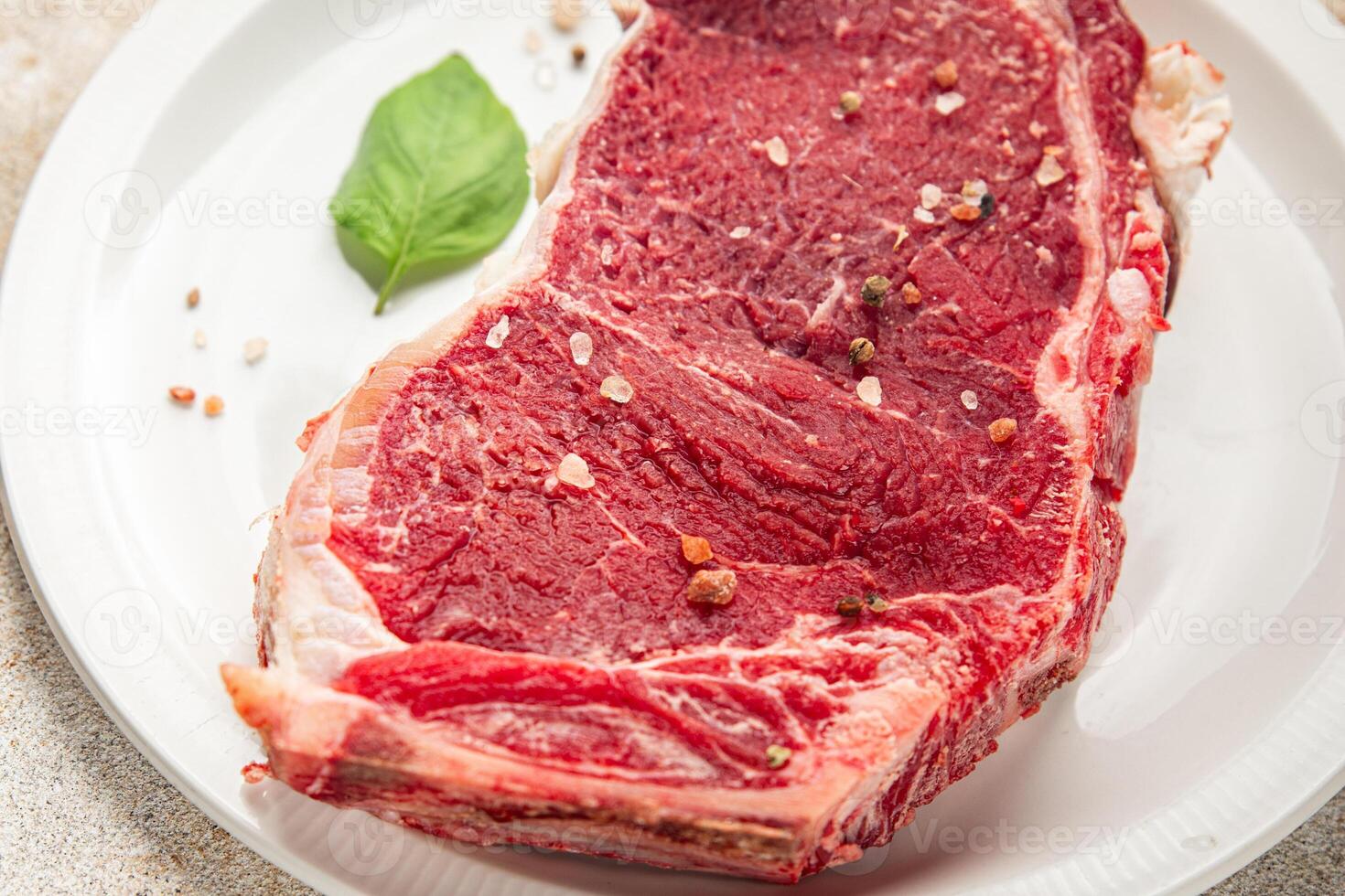 Raw beef steak bone-in meat fresh tasty food dish delicious gourmet food background on the table photo