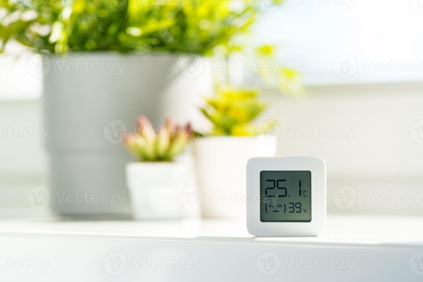 White Digital Thermometer Displaying Room Temperature and Humidity photo