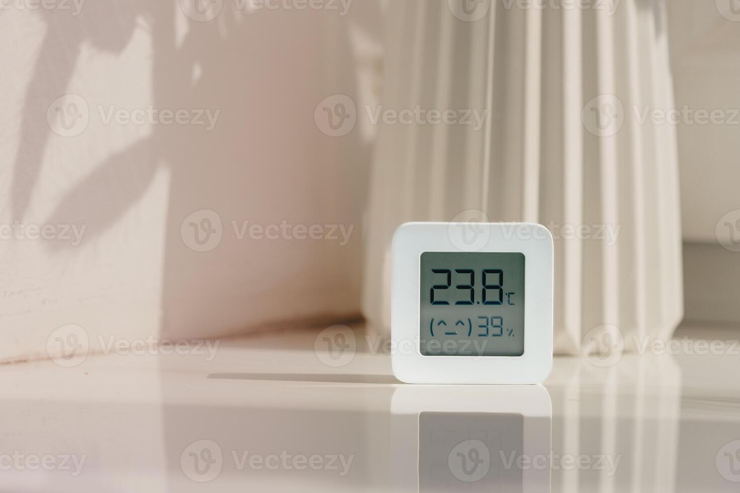 White Thermometer and Hygrometer on a White Surface With a Shadow photo