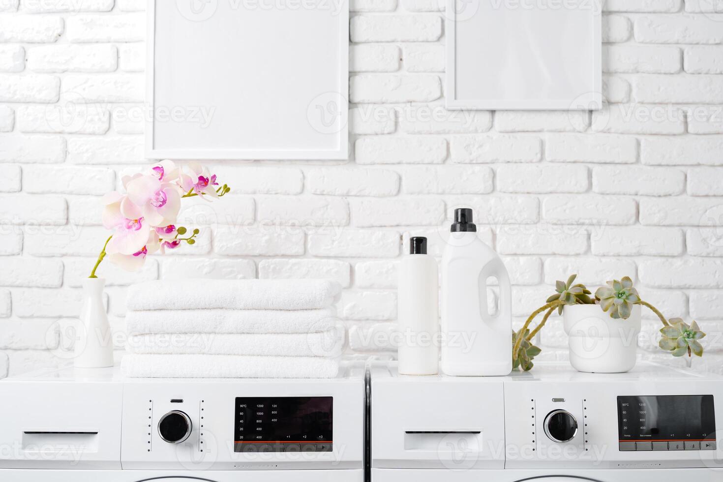 Two White Front Loading Washing Machines in Modern Laundry Room photo
