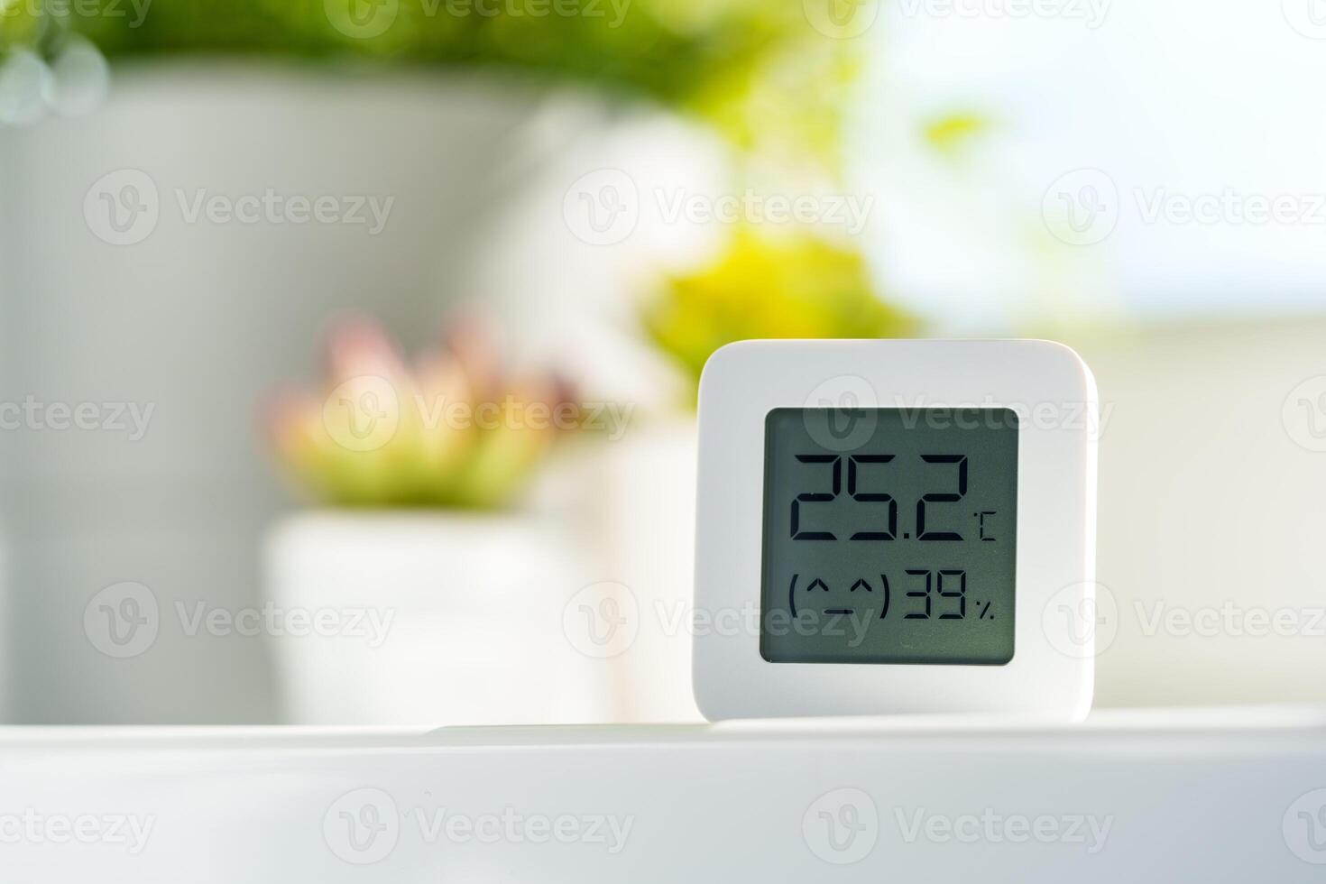 White Digital Thermometer Displaying Room Temperature and Humidity photo