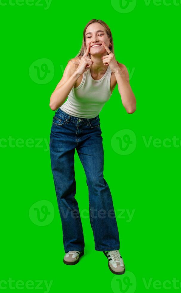 Young Woman With Blonde Hair Posing Against Green Screen photo