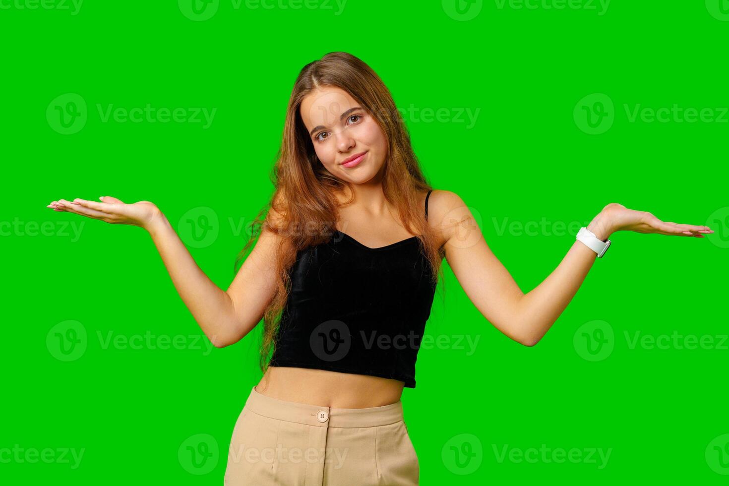 Young Woman in Black Top Holding Out Her Arms against green background photo