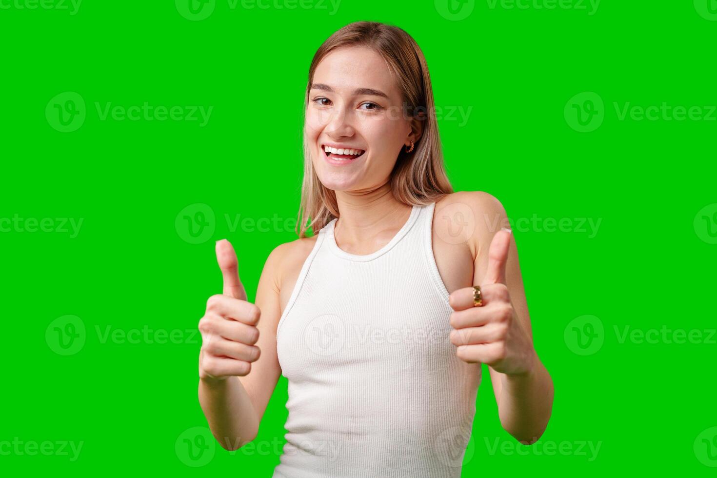 Happy Woman Giving Thumbs Up Against Green Screen photo
