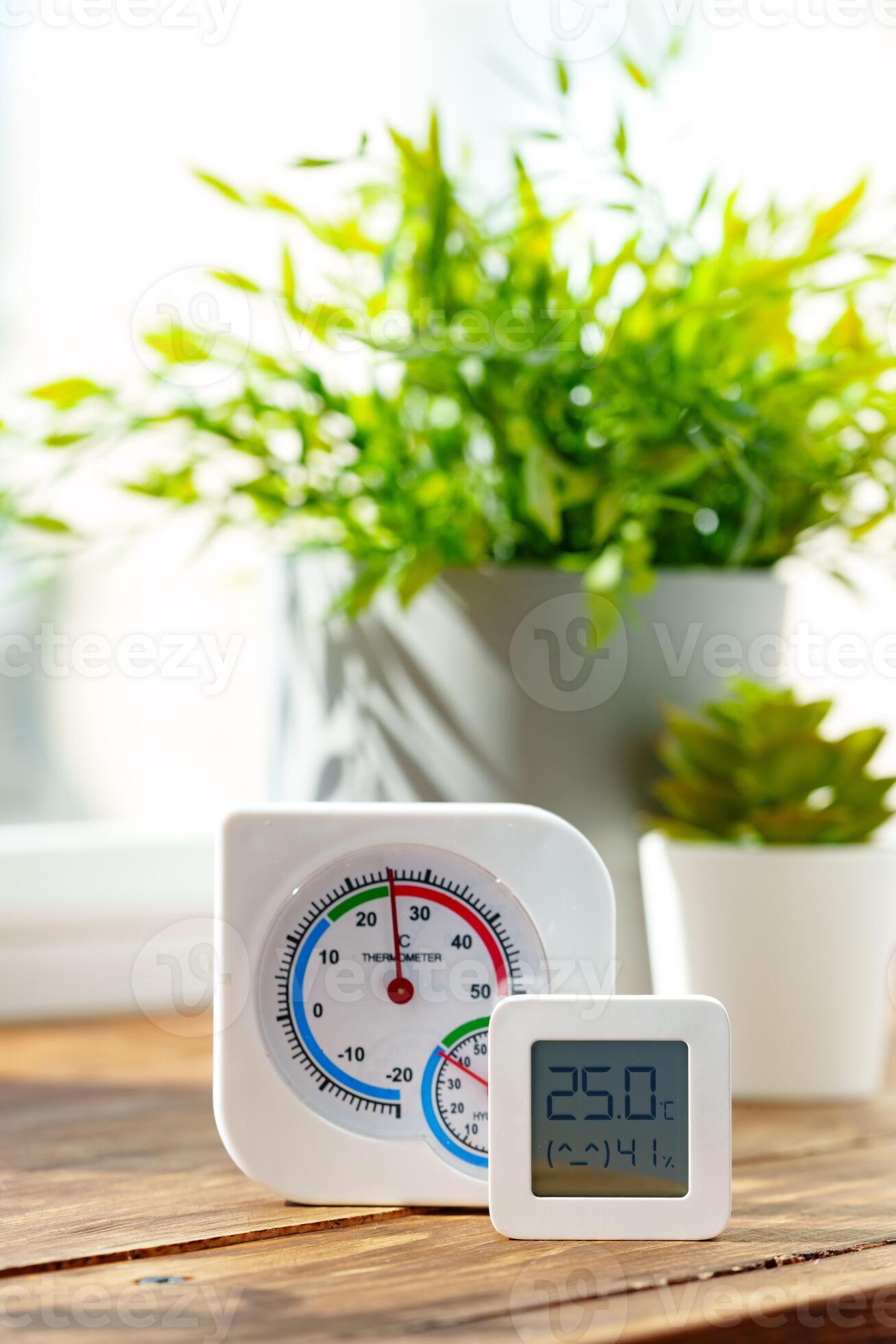Digital Thermometer Displaying Temperature and Humidity Near Window ...