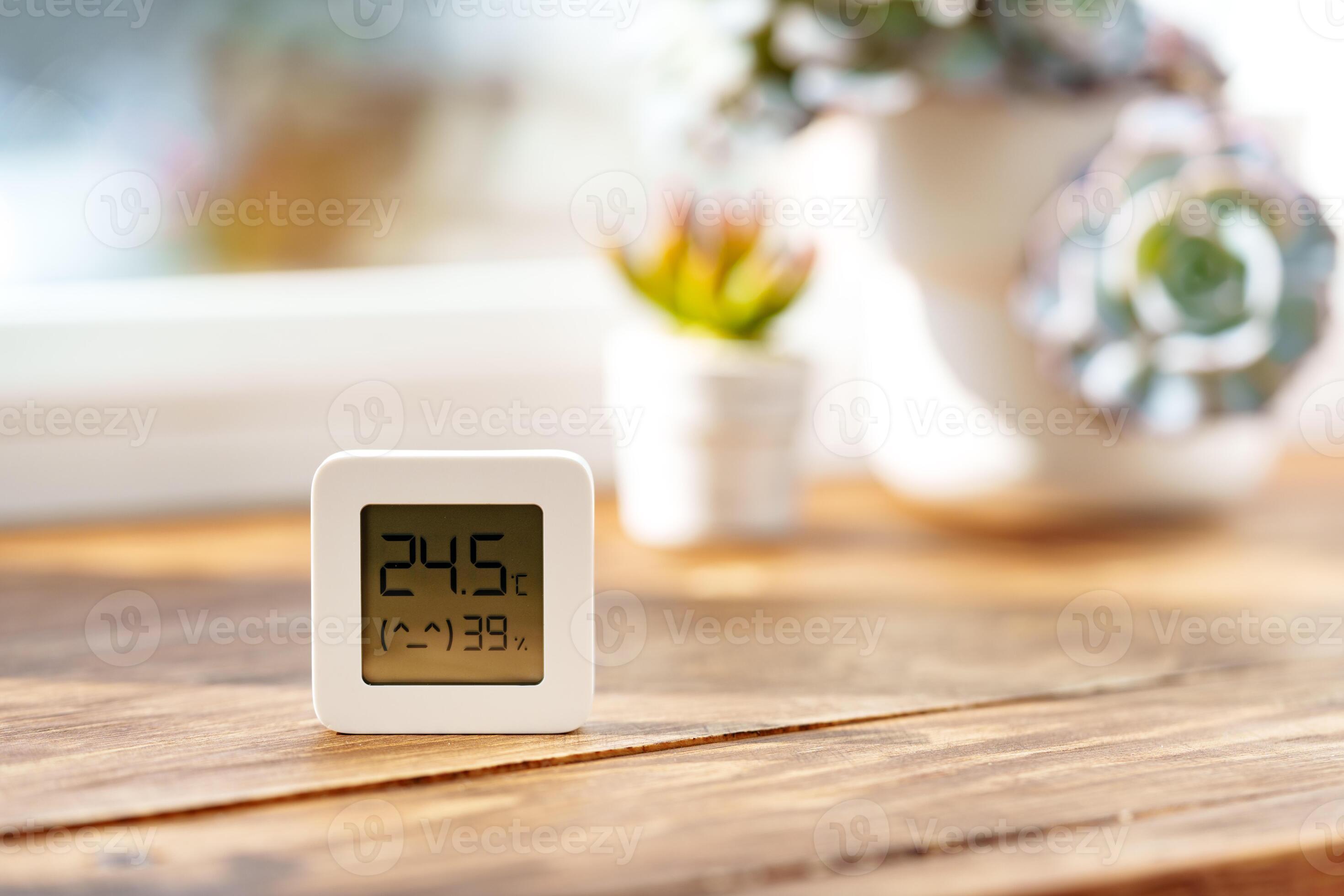 Digital Thermometer Displaying Temperature and Humidity Near Window ...