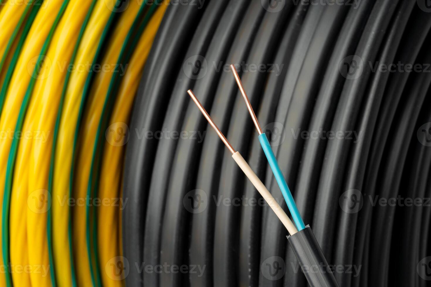 Close Up Of Black Electrical Wire Coil With Blue And White Wires photo