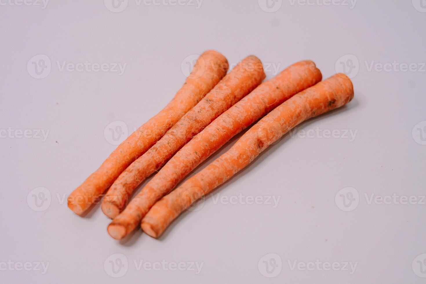 Fresh carrots displayed against a clean white background, highlighting their vibrant orange color and crisp texture photo