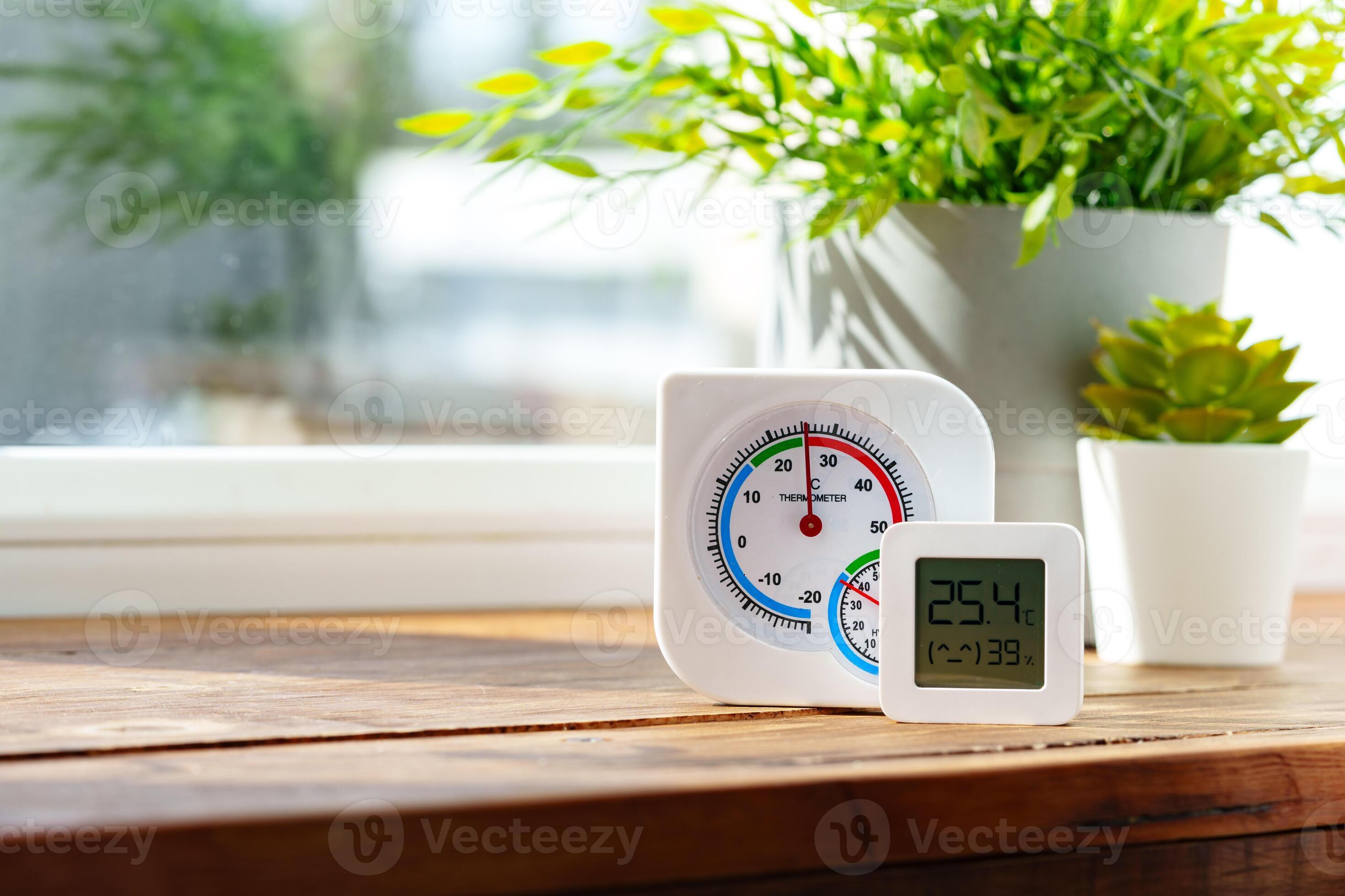 Digital Thermometer Displaying Temperature and Humidity Near Window ...