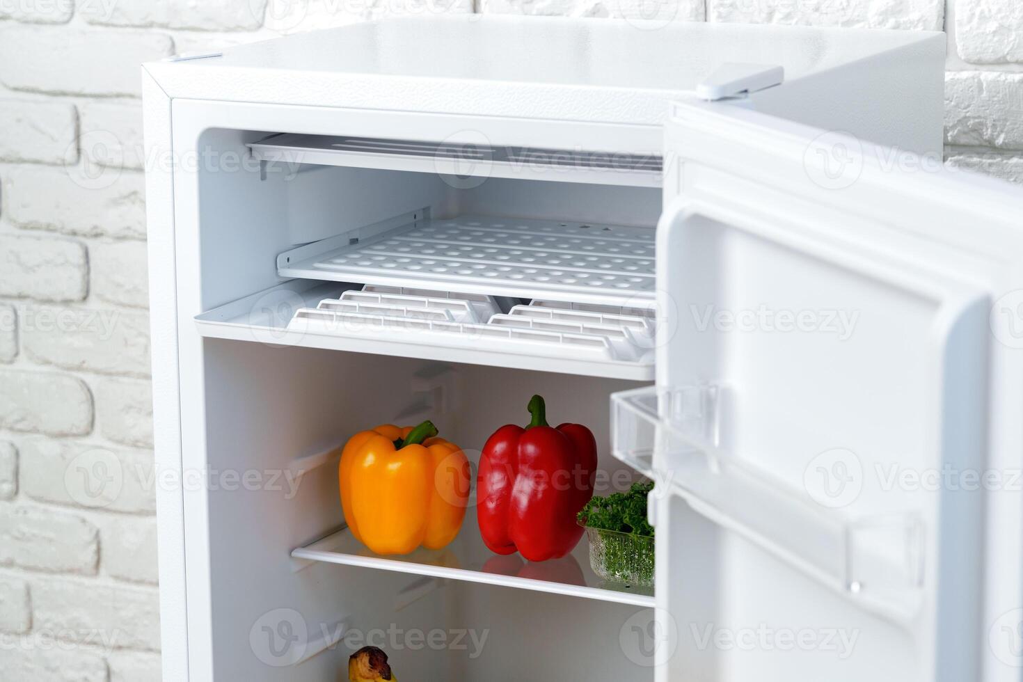 Open Refrigerator Door Showing Fresh Produce Inside photo