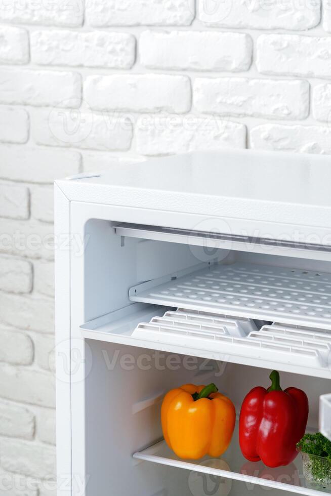 Open Refrigerator Door Showing Fresh Produce Inside photo