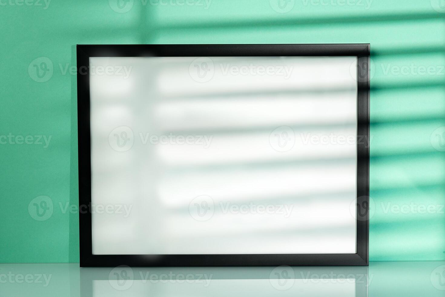 Black frame mock up against mint background with shadow photo
