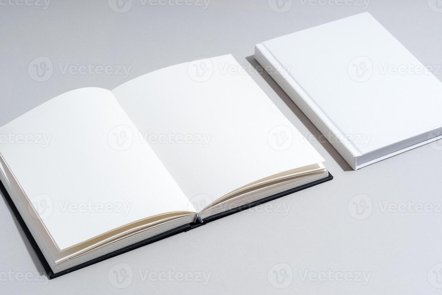 Blank open notepad on gray background studio shot photo