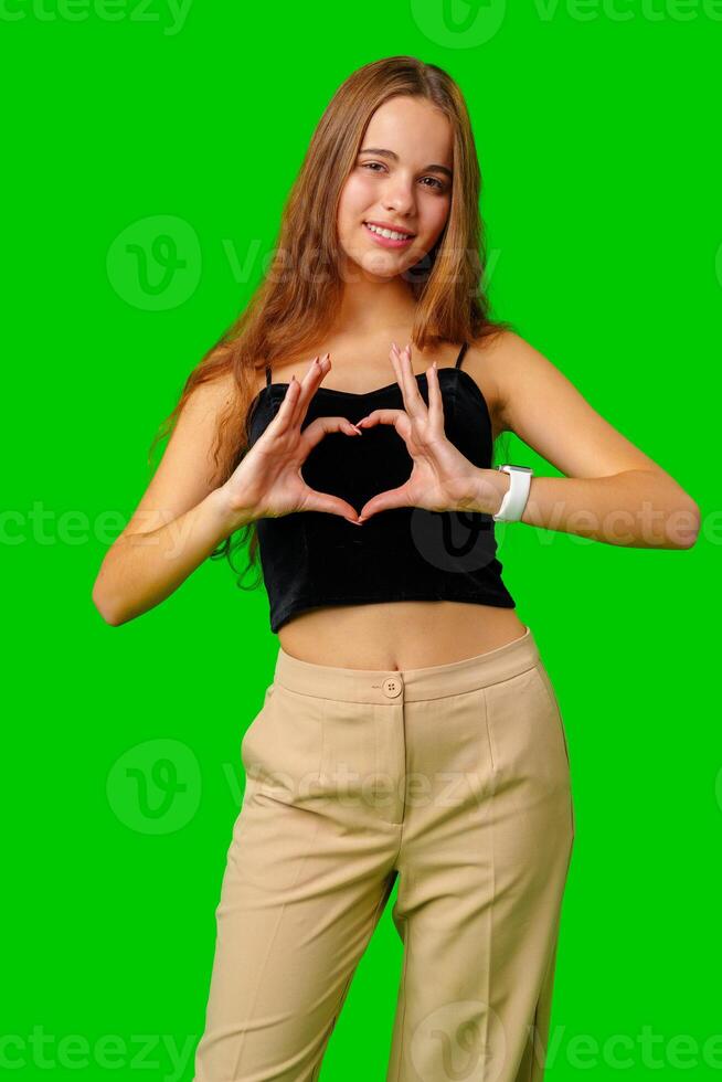 Young Woman Making Heart Gesture With Hands photo