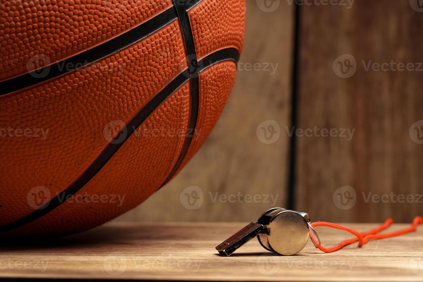 Basketball ball lying on a wooden floor photo