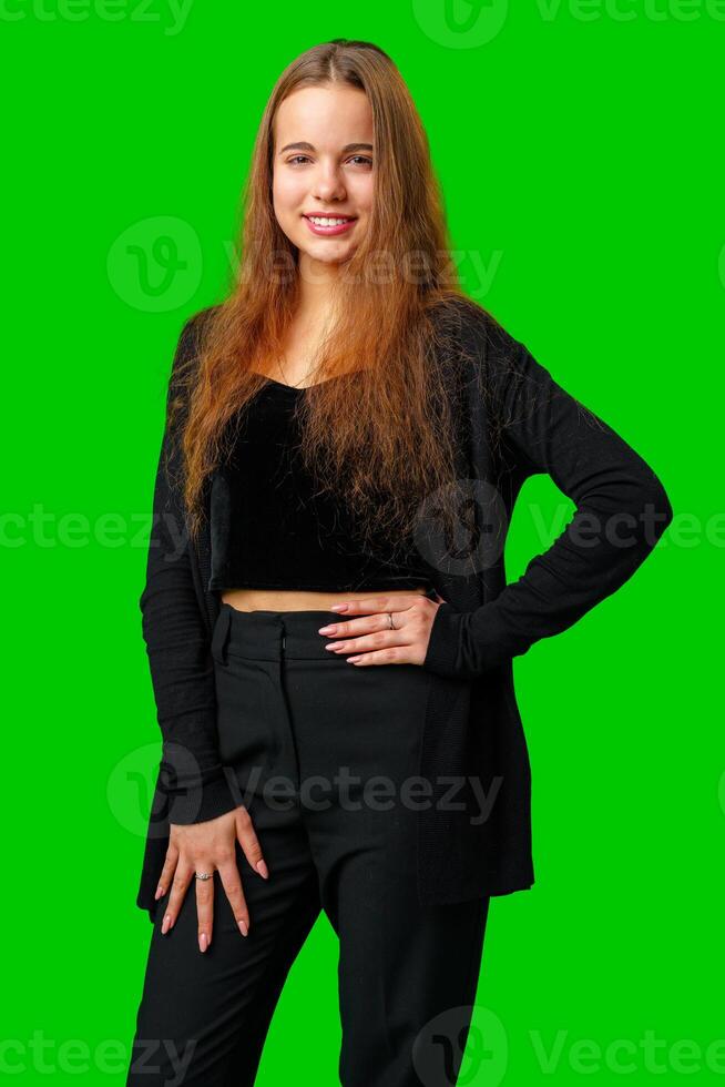 Young Woman With Long Hair Standing in Front of Green Screen photo