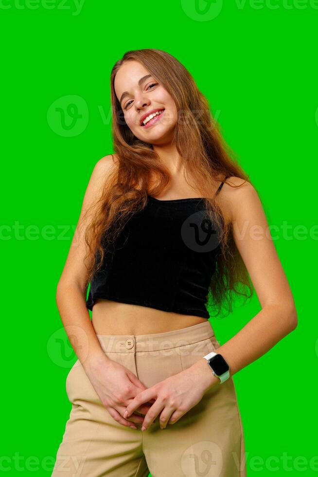 Smiling Young Woman in Black Top and Tan Pants Portrait photo