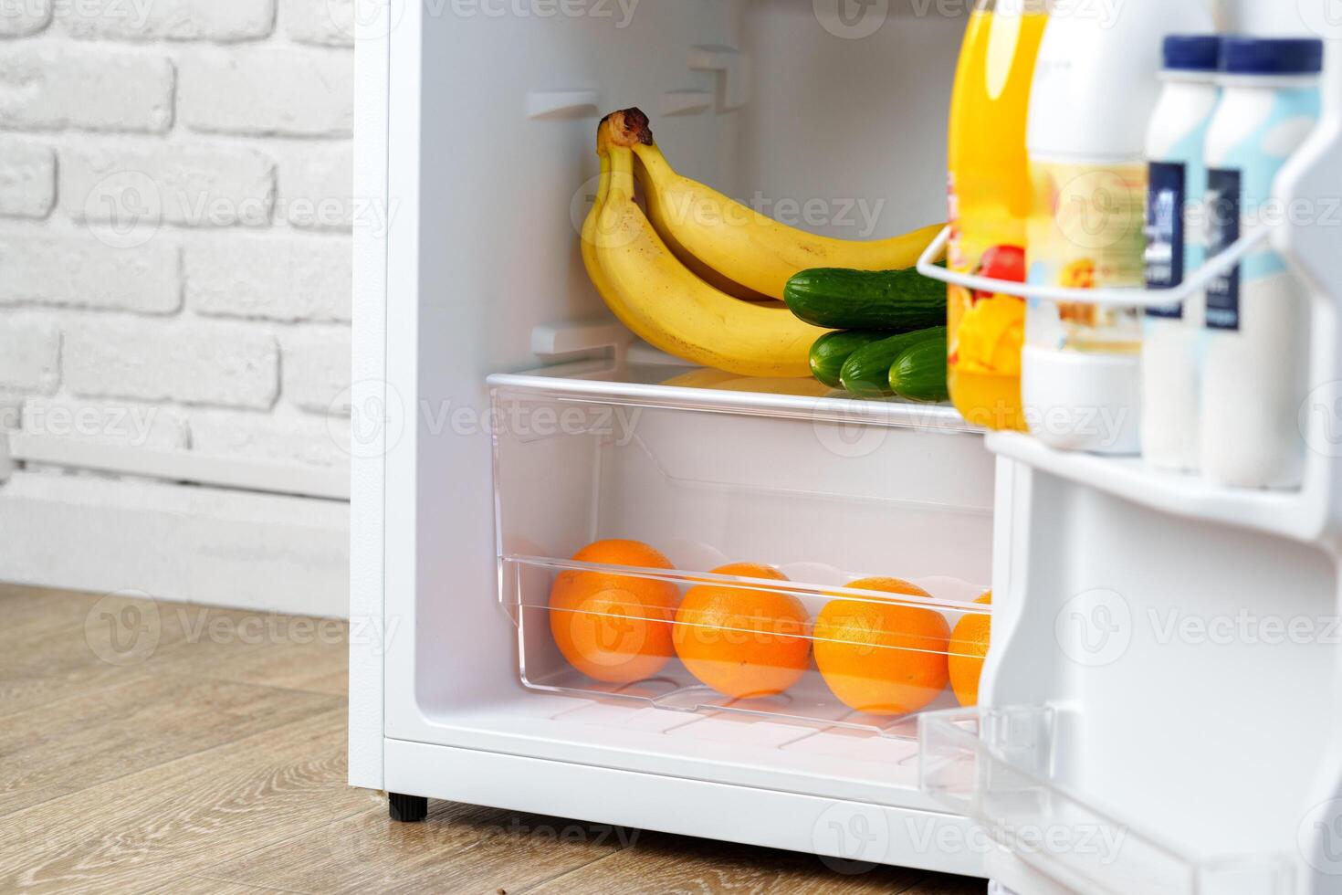 Open Refrigerator With Fresh Produce and Juice photo