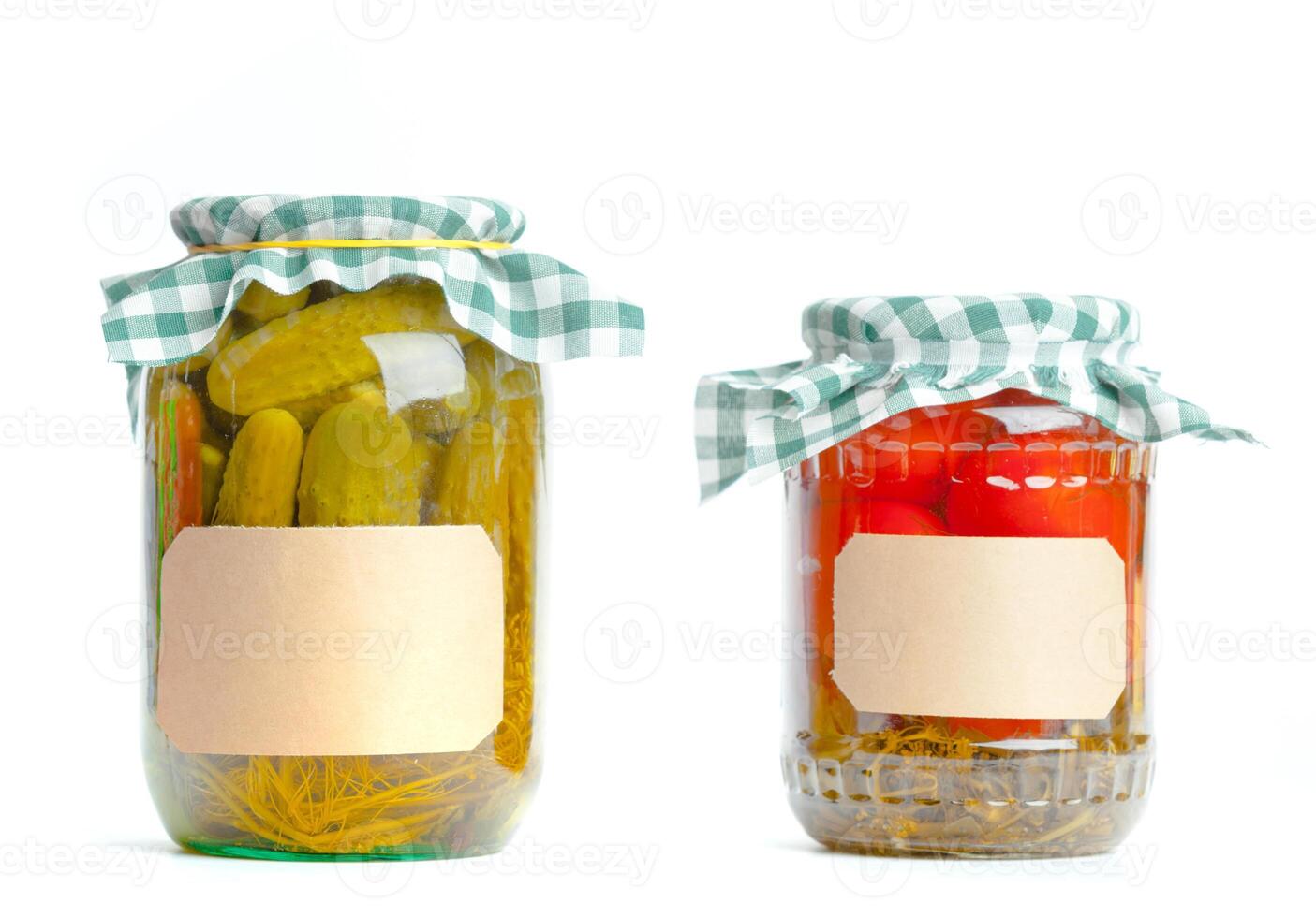 Canned vegetables in glass jars isolated on white background photo