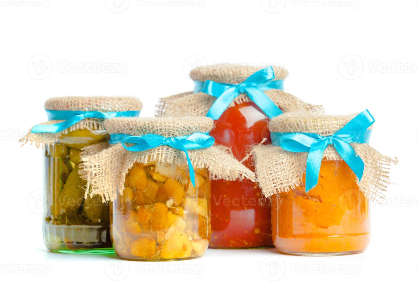 Canned vegetables in glass jars isolated on white background photo