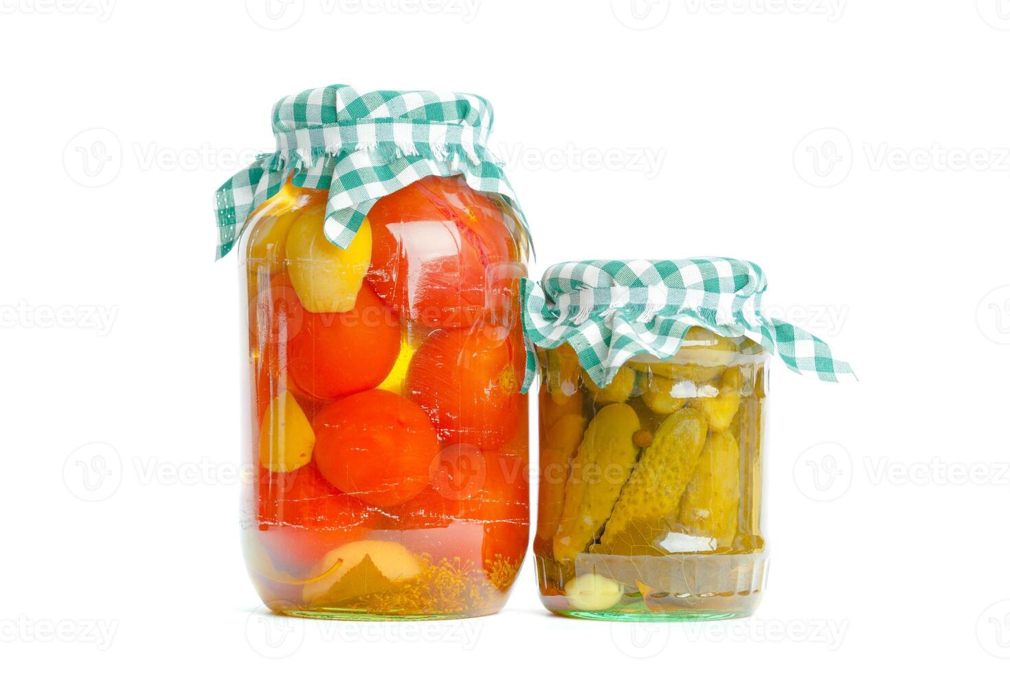 Canned vegetables in glass jars isolated on white background photo